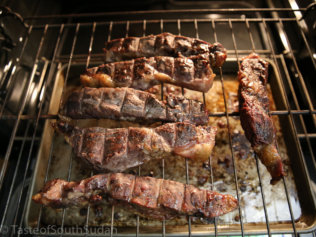 Pictured above are smoked meat in an oven. South Sudan food, Sudanese food, African food.