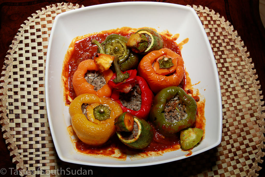Mahshi, roasted stuffed zucchini and bell peppers, in a bed of tomato sauce. South Sudan food, Sudanese cuisine, North Africa, and Mediterranean cuisine.
