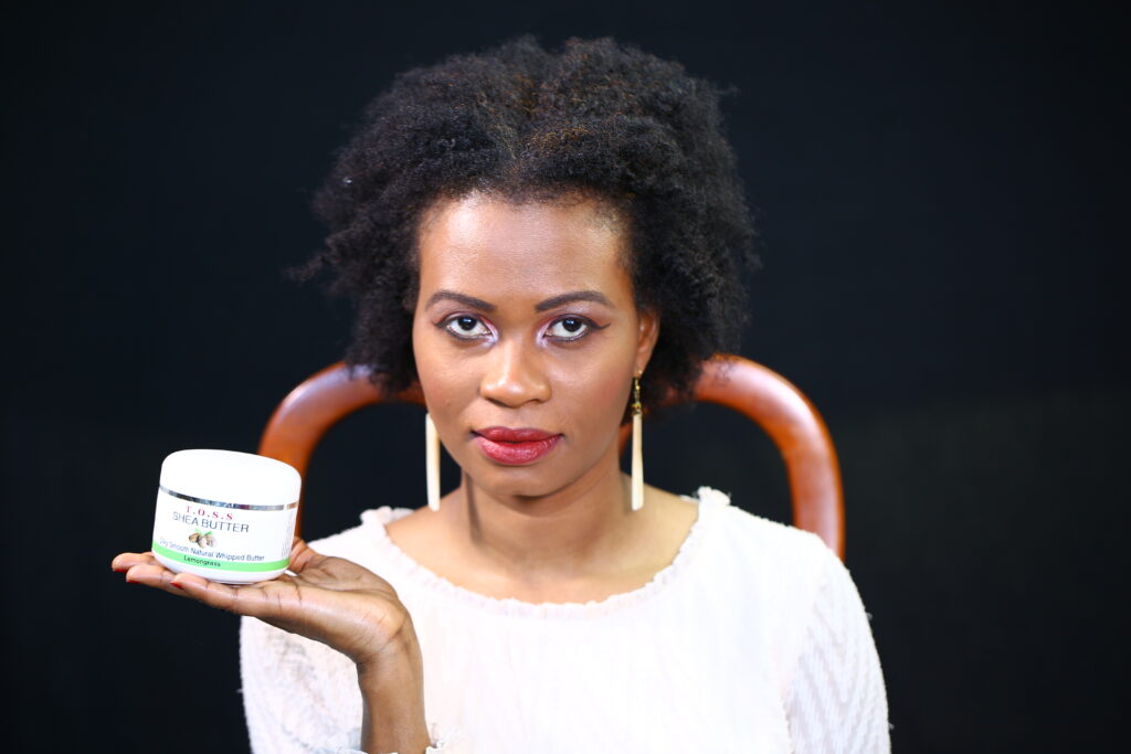 Dr. Mogga, Founder of Taste of South Sudan, holding 1st Shea Butter Nilotica product