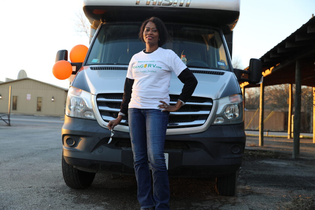 Dr. Noela Mogga, MangoRV Co-Founder, in front of their RV for Rentals